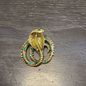 Gold snake brooch with green rhinestones